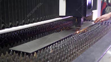 Sparks fly from laser by automatic cutting CNC