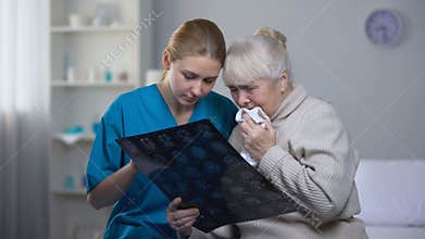 Nurse explaining elderly lady examination results, supporting old female patient
