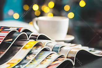Stack Magazines place or Old books on black desk with coffee cup background. selective focus