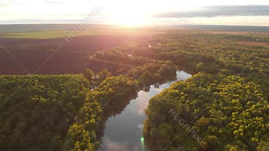 River aerial landscape cinematic drone footage at sunset time. Flying above Dniestr river in Ukraine or Moldova with