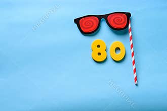 Flat lay top view number and sunglasses cute paper carnival mask.
