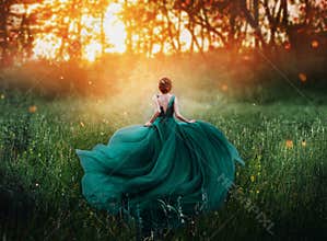 Magical picture, girl with red hair runs into dark mysterious forest, lady in long elegant royal expensive emerald green