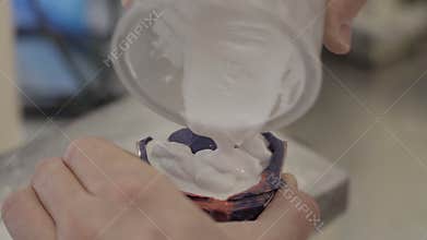 Dental technician preparing mixture for teeth mold. Making of artificial teen in the dental lab. Professional poring polymer mater