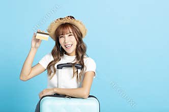 tourist girl in summer hat showing credit card