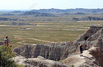 Two unidentified tourist enjoying the view of Badlands National Park in South Dakota