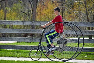 Young Boy, Old Fashioned Bicycle Riding