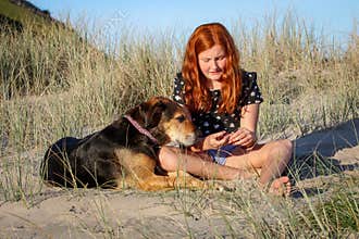 Red haired girl with pet dog