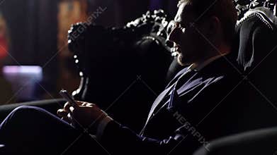 Rich lifestyle, professional success, profit, finance concept. Bearded man with confident face holds dollars