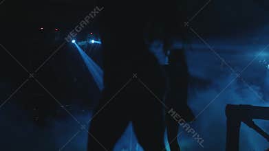 Silhouettes of people dancing in the dark