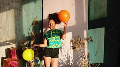 Model dancing with balloons in his hands