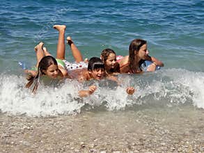 Happy childrens enjoy on waves