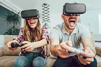 Young funny couple playing video games