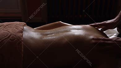 Ayurveda Massage concept. Beautiful young woman reciving relxing Massage of Back from Professional Masseur, Abyanga