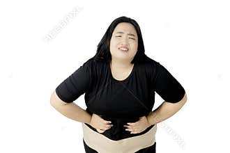 Obese woman suffering from abdominal pain