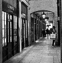 A black and white shot of a male shopper outside Links of London Covent Garden, London UK