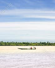 A pirogue navigates on the river niger