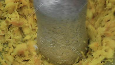 Pounding ginger with pestle