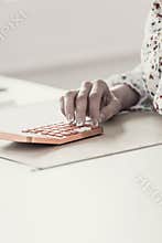Toned image of female accountant or banker making calculations