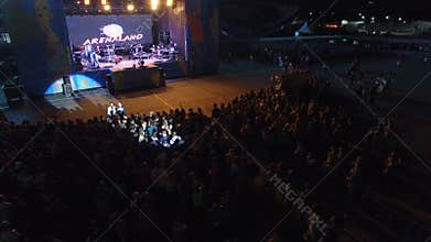 Drone Flies over People Crowd Listening Concert Hosts