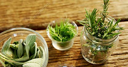 Various herbs in a jar on wooden table 4k