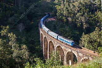 Nine Arches Bridge and blue train in Sri Lanka, Ella.