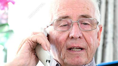 Senior Man Giving Credit Card Details On The Phone