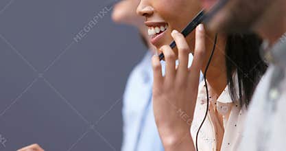 Smiling customer service executives talking on headset at desk 4k