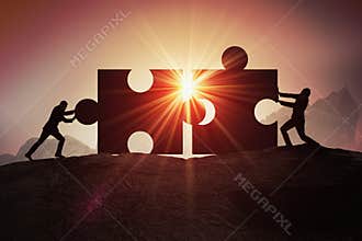 Teamwork, partnership and cooperation concept. Silhouettes of two businessman joining two pieces of puzzle together