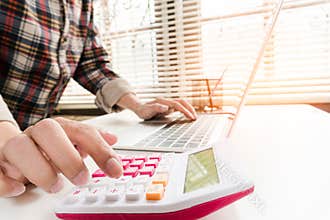 Close up accountant or banker making calculations.
