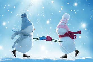 Two ice skating snowmen