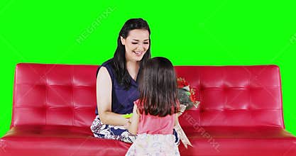 Child giving a bouquet to her mother