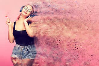 Conceptual image of woman listening to music and holding a