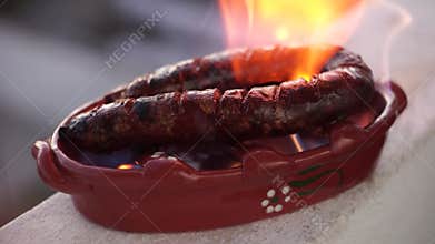 Roasted sausage prepared in special clay pot with alcohol, Portugal