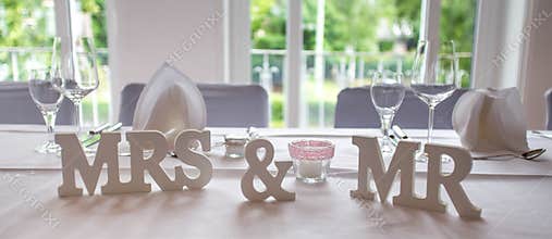 Mrs and mr wedding signs on a plain table