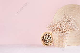Elegance home eco decor - white dried flowers bouquet in basket with decorative plate, bunch sticks on fashion pink background.