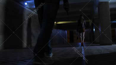 Male legs with knife chasing woman in tunnel