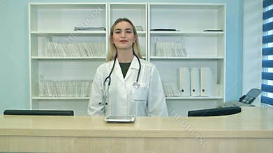 Smiling female doctor with stethoscope at the reception