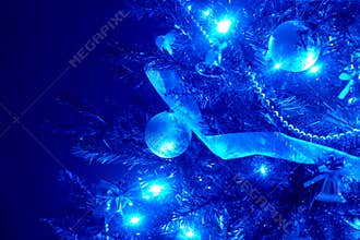 Blue background with christmas tree, ball, light.