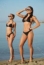 Two fitness women on the beach