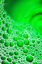 Green bubbles. Selective focus aesthetic liquid pattern background image.