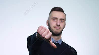 Young man showing thumbs down. Studio shot. White Background