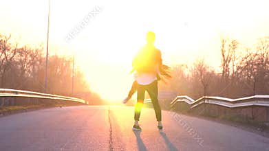 A loving couple at dawn on the road, a man is circling a woman in the air