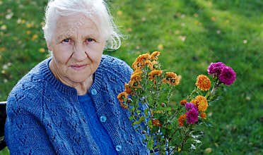 Elderly woman on green meadow