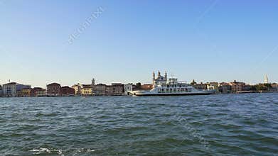 Touristic ship sailing along embankment with attractions in Venice, transport