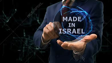 Businessman shows concept hologram Made in Israel on his hand