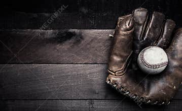 Vintage baseball gear on a wooden background