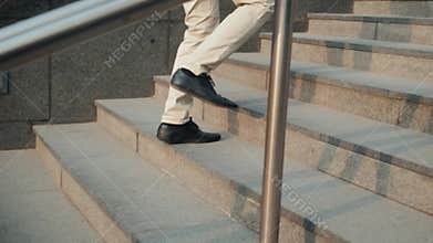 Walking upstairs: close-up view of man`s leather shoes business stairs run walk