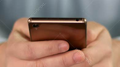 Close-up of man's hands scrolling on smartphone, mobile business application