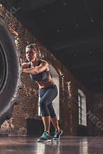Athletic woman with a crossfit wheel