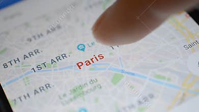 Gomel, Belarus - May, 2018: Person using a Google Maps application on Android device. Paris mobile map using